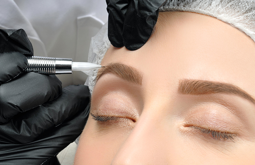 A girl having eyebrow microblading done